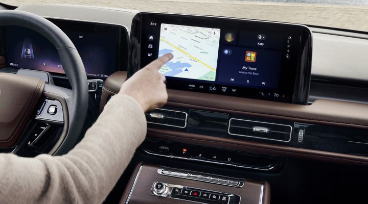 A person is tapping the center display touchscreen of a 2026 Lincoln Aviator® SUV. | Lincoln of Troy in Troy MI