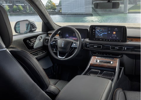 The interior of the 2026 Lincoln Aviator® SUV is shown parked with a view of a harbor through the windshield. | Lincoln of Troy in Troy MI