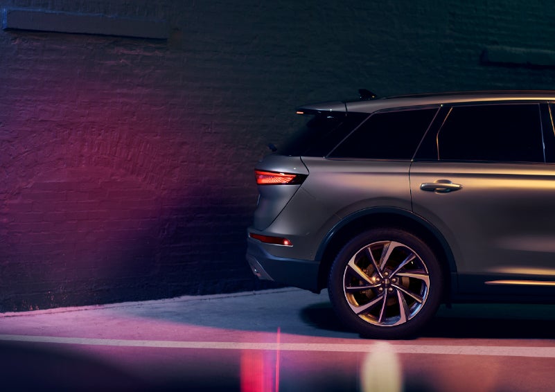 A dramatization of a 2026 Lincoln Corsair® SUV backing up toward a wall is shown. | Lincoln of Troy in Troy MI