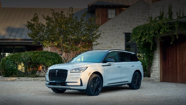 A 2026 Lincoln Corsair® SUV is parked in front off a luxury home. | Lincoln of Troy in Troy MI