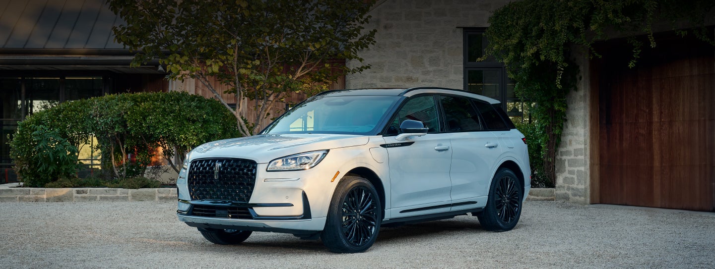 A 2026 Lincoln Corsair® SUV is parked in front off a luxury home. | Lincoln of Troy in Troy MI