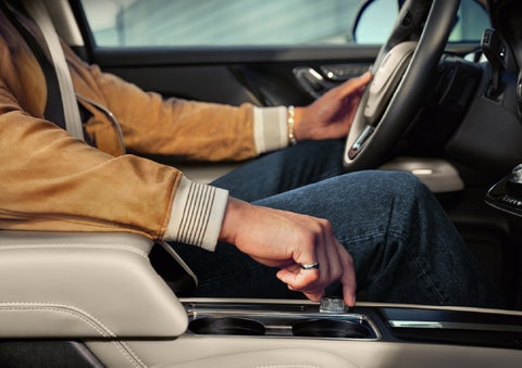 The driver of a 2026 Lincoln Corsair® SUV is shown selecting a drive mode. | Lincoln of Troy in Troy MI