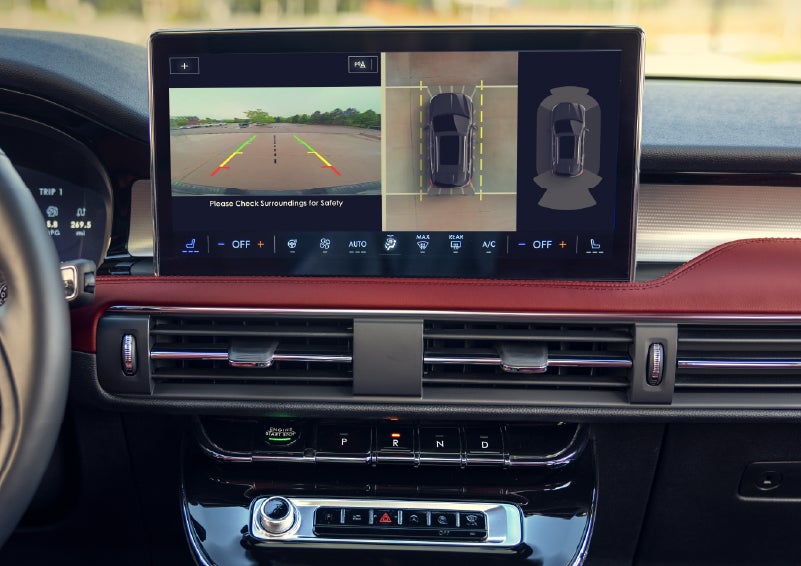 A couple approaches a 2026 Lincoln Corsair® Reserve model as the Lincoln Embrace illumination guides the way | Lincoln of Troy in Troy MI