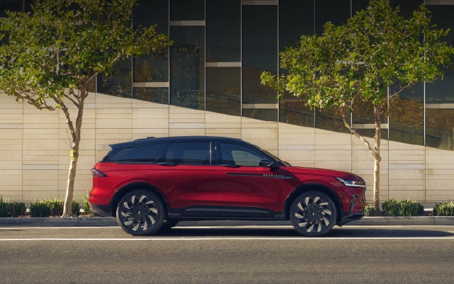A 2026 Lincoln Nautilus® SUV with an available Hybrid Powertrain is parked in an urban setting. | Lincoln of Troy in Troy MI