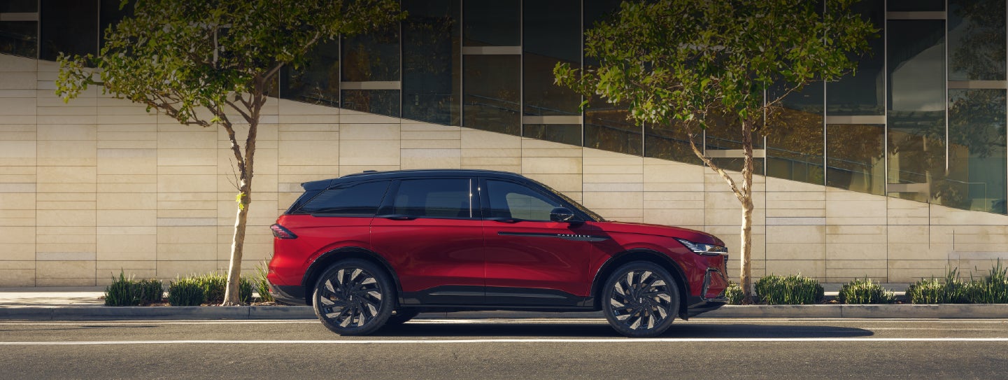A 2026 Lincoln Nautilus® SUV with an available Hybrid Powertrain is parked in an urban setting. | Lincoln of Troy in Troy MI