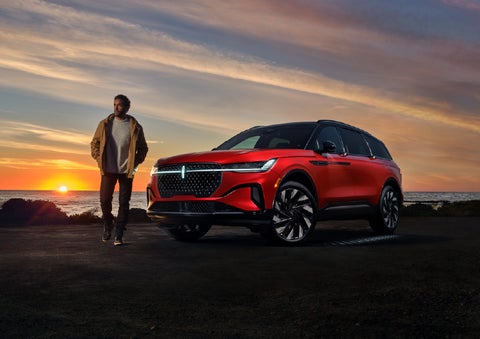 A person is shown next to a 2026 Lincoln Nautilus® SUV as the Lincoln Embrace sequence takes place. | Lincoln of Troy in Troy MI