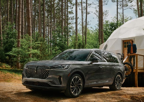 A 2027 Lincoln Aviator® is parked next to a high end glamping site. | Lincoln of Troy in Troy MI