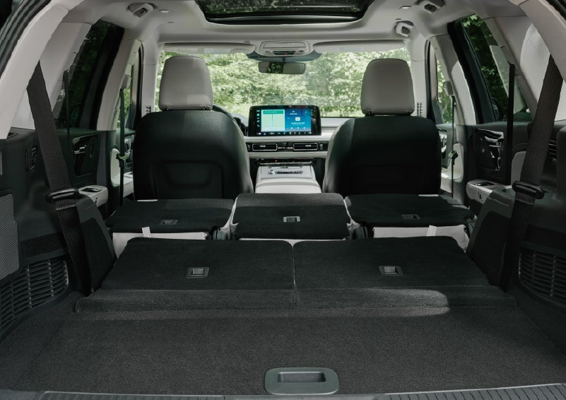 A rear to front view of the interior of a 2027 Lincoln Aviator® Black Label™ SUV shows the third and second rows folded flat | Lincoln of Troy in Troy MI