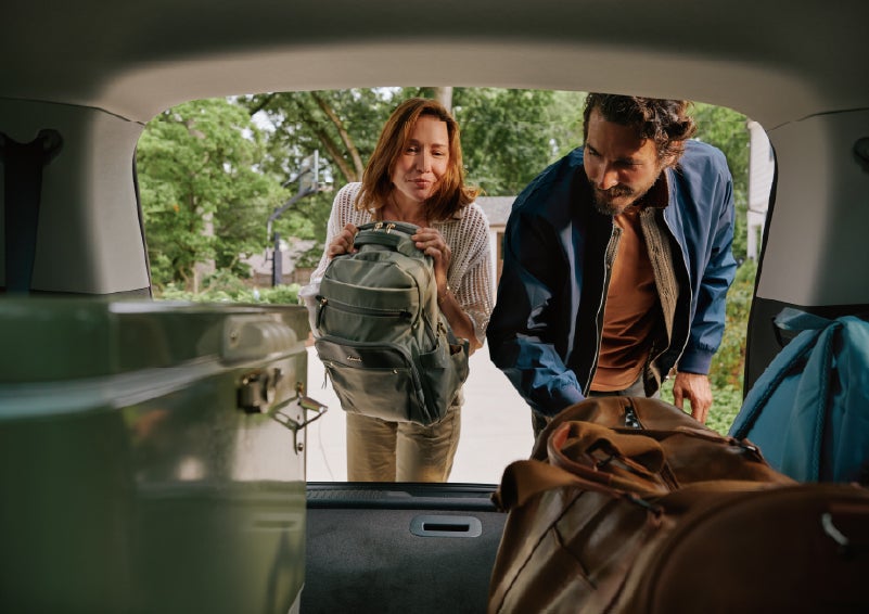 A couple loads luggage into the rear of a 2027 Lincoln Aviator® Black Label™ SUV..e 202 | Lincoln of Troy in Troy MI