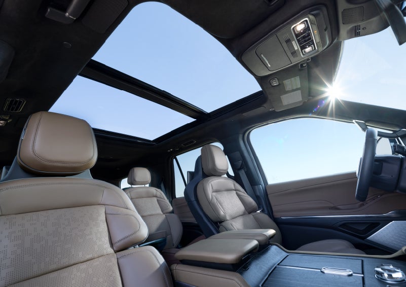 The panoramic Vista Roof® allows sun to fill the cabin of a 2027 Lincoln Navigator® Black Label™ SUV.