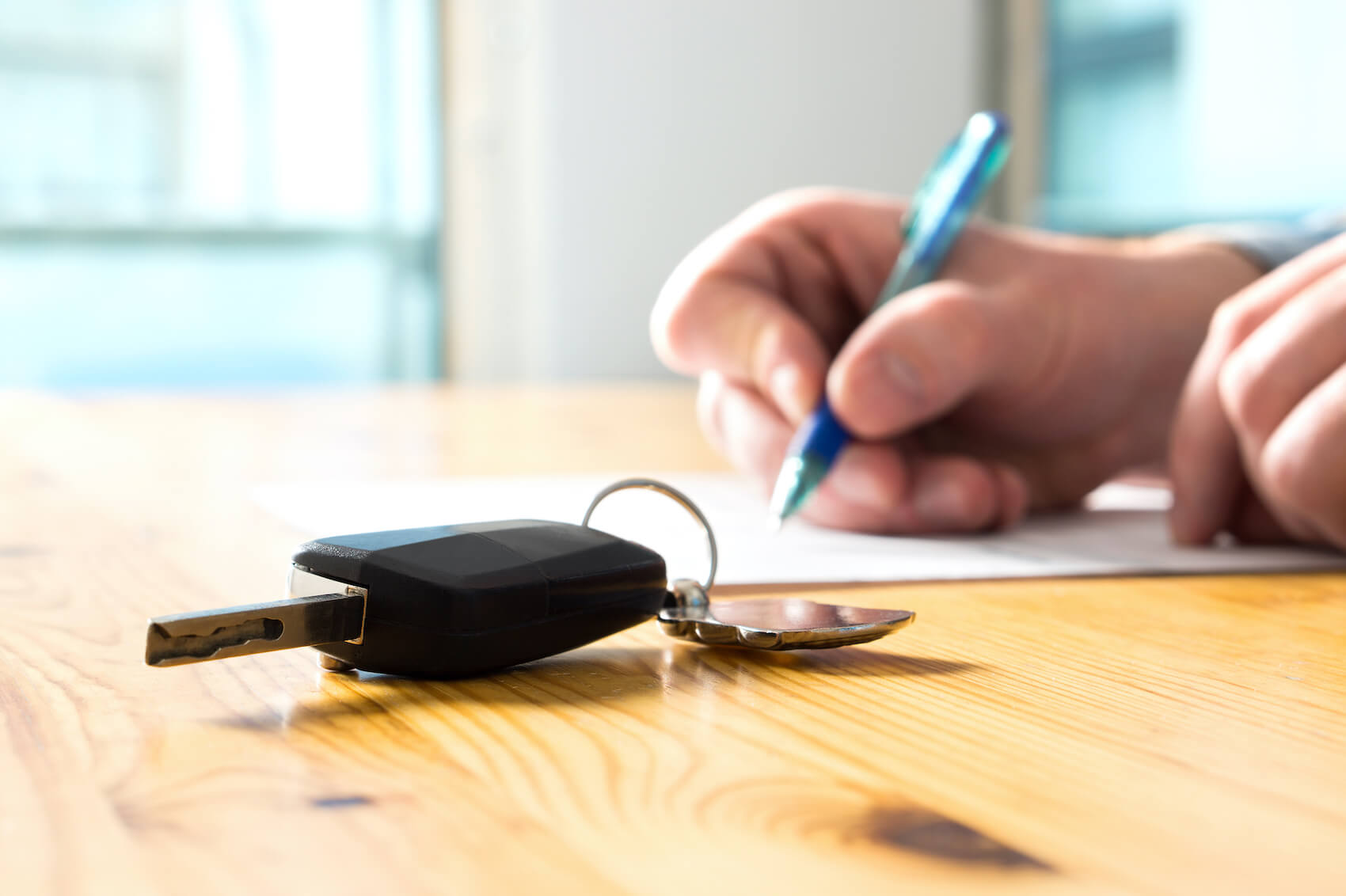 signing a car financing paper