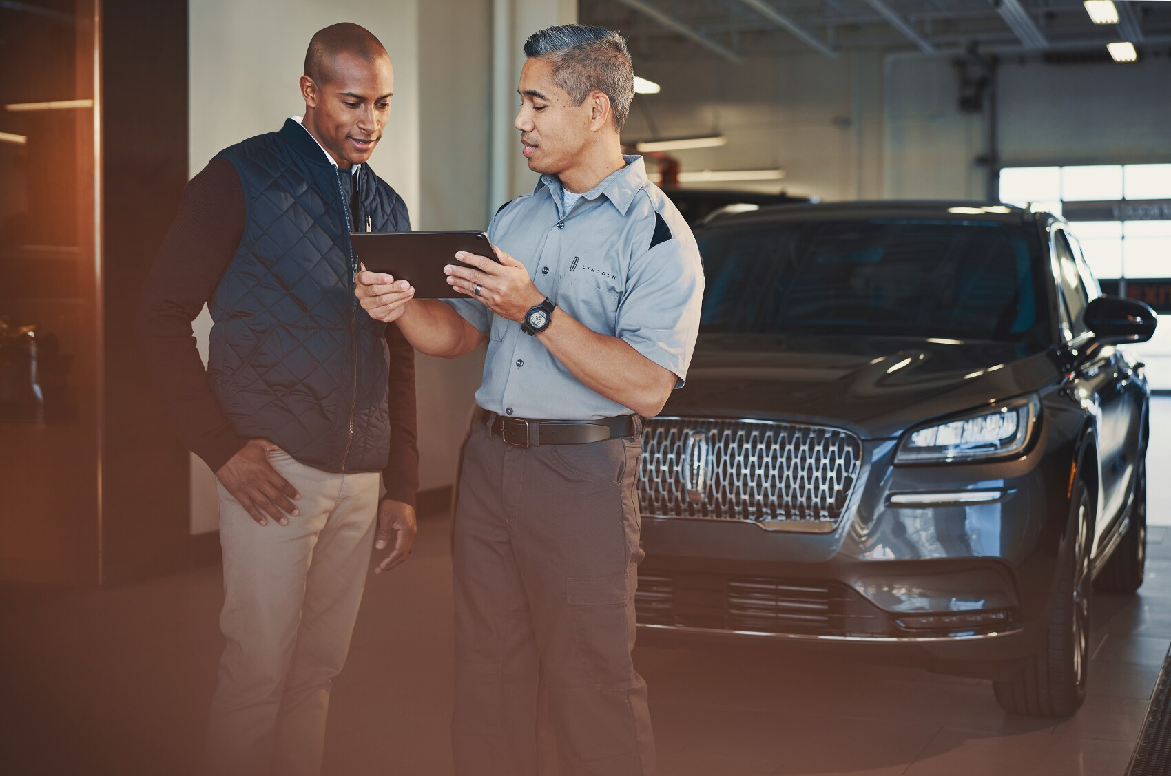 technician showing options on clipboard to customer