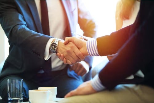 Sales manager and customer shaking hands
