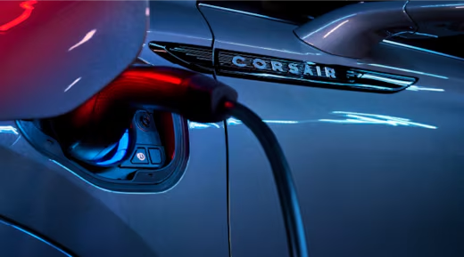 A charger plugged into the charging port of a 2025 Lincoln Corsair® Plug-in Hybrid model.