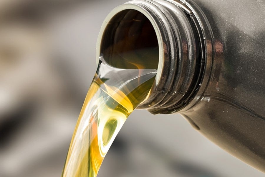 Close-up of motor oil being poured from a container